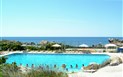 Residence Baia Santa Reparata - Pohled od bazénu k moři, Santa Reparata, Sardinie, Itálie.